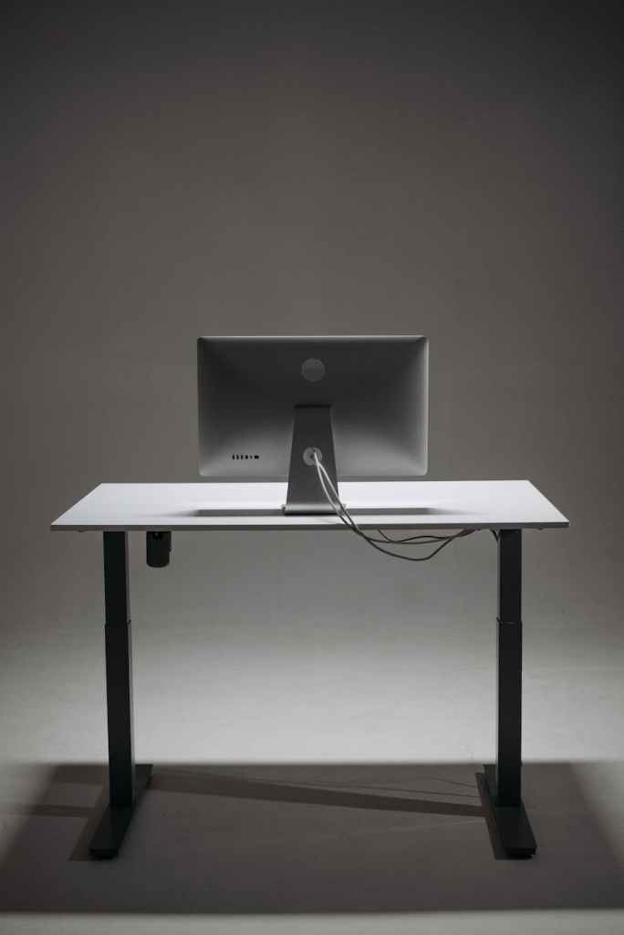 a monitor on a height adjustable desk